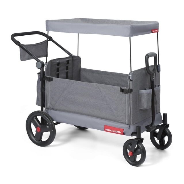 Radio Flyer Journey Stroll 'N Wagon in grey with UV protection canopy, four wheels including large 12-inch rear wheels and front caster wheels, push handle with parent caddy and cup holders, rear storage bag, internal pockets, and zip-down side for bench seating or easy entry, suitable for outdoor garden use.