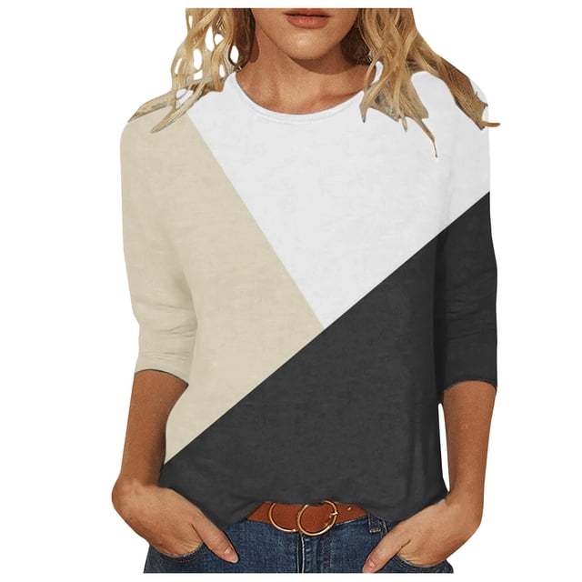 3/4 Sleeve Tops for Women featuring a crewneck design and contrasting color blocks in beige, white, and black. This casual and slim-fit top has 3/4 sleeves and is made from imitation cotton fabric, suitable for spring and summer wear. The model pairs it with blue jeans and a brown belt.