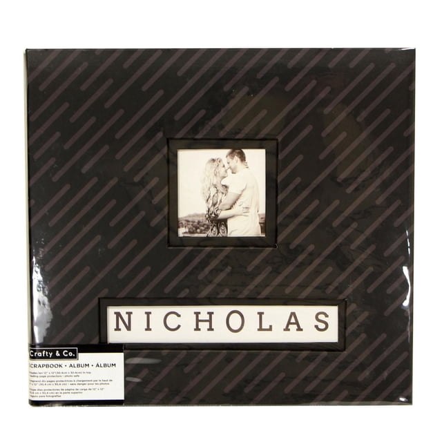 CRAFTY & CO. Scrapbook, Photo Album with black cover featuring diagonal stripe pattern, a centered square photo frame, and a rectangular window below showing the name NICHOLAS in black letters on white background, designed for preserving photos and memories with 10 sheets.