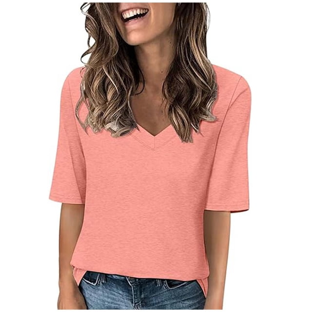 Timegard Womens Tops V-Neck 1/2 Sleeve Solid Color Basic Tee Shirts Comfy Blouse Casual Tunic Tops. The image shows a woman wearing a light pink V-neck top with half sleeves, styled casually with blue jeans. The top features a simple and relaxed silhouette, suitable for layering with cardigans or jackets. Ideal for pairing with various bottoms like jeans or leggings for a chic yet comfortable look.