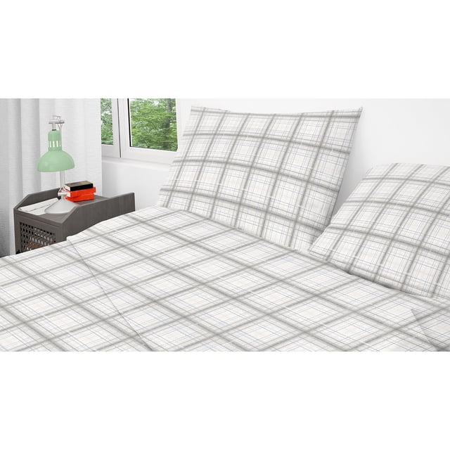 Cotton House - Flannel Sheet Set, 100% Cotton, Twin Size, Striped Plaid Design. The image shows a twin-size bed dressed in a soft flannel sheet set with a grey and white striped plaid pattern. The set includes a fitted sheet, flat sheet, and pillowcase, all made from 100% cotton with a double-brushed finish for extra softness. The fitted sheet is designed to fit mattresses up to 16 inches thick. The bed is placed in a bright, modern bedroom with a side table and a green lamp.