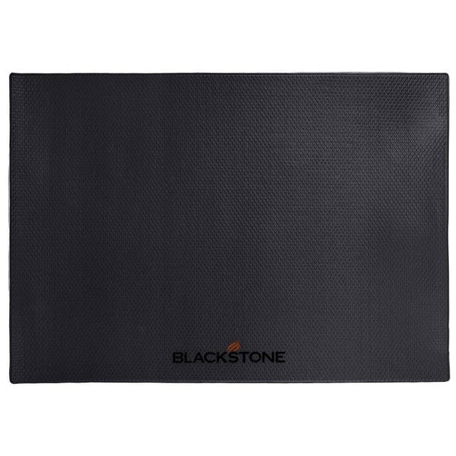 Blackstone 48” x 32” Griddle or Grill Mat with black textured slip-resistant foam top and fire-resistant natural fiber backing, designed to protect wood, composite, stone, or cement patios from oil spills and provide a stable surface for outdoor griddles.