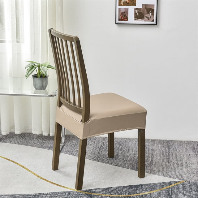 Zanvin waterproof seat cover for dining room chairs, crafted from beige artificial leather with a snug fit on a wooden chair. Features a rear-gapped design for easy installation, elastic edges for secure placement, and a removable, washable design. Protects chairs from spills, scratches, and wear, suitable for dining and kitchen use.