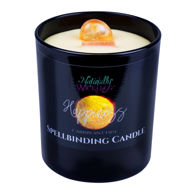 Naturally Wicked Spellbinding Happiness Candle featuring a black jar with vibrant sunburst wax and a visible Citrine Crystal embedded near the crackling wooden wick. The candle is scented with Caribbean Curse, an exotic fruit infusion, and includes a luxury steel lid. Handcrafted from natural plant wax, it comes with a shimmering iridescent spell book and is gift-boxed for a magical presentation.
