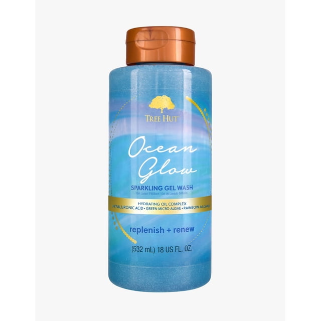 Tree Hut Foaming Gel Wash Ocean Glow, 18 fl oz, in a blue bottle with a golden flip-top cap. The label emphasizes its hydrating oil complex with hyaluronic acid, green microalgae, and rainbow algae. This body wash cleanses and moisturizes skin while being formaldehyde-free, paraben-free, and sulfate-free.