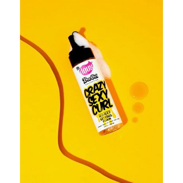HONEY FOAM Crazy Sexy Curl honey setting foam bottle with black pump dispenser and white foam on top, placed on bright yellow background with honey droplets and a curved honey trail, a curl defining mousse that hydrates, protects, and sets hair with flexible hold and no frizz.