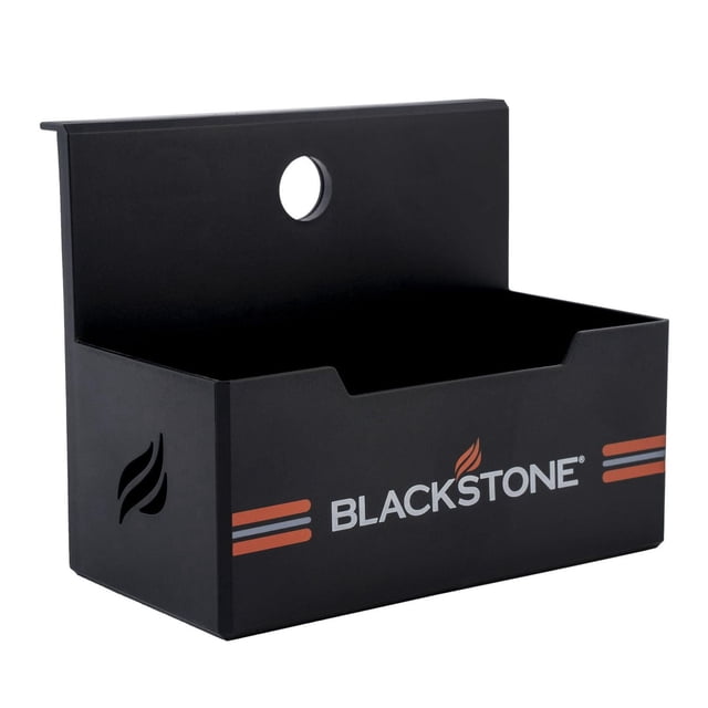 Blackstone Magnetic Griddle Accessory Tray in matte black with a rectangular open container design, featuring the Blackstone logo and orange stripes on the front, a circular hole on the back panel for mounting, magnetically attaches to metal surfaces for kitchenware and utensil storage, ideal for organizing cooking tools and bottles.