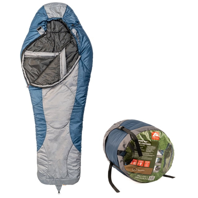 Ozark Trail -10℃ mummy sleeping bag in grey and blue polyester, 34 by 90 inches, shown open with padded interior and contoured hood, alongside its compression carry bag with straps and label, designed for cold weather camping and compact storage.