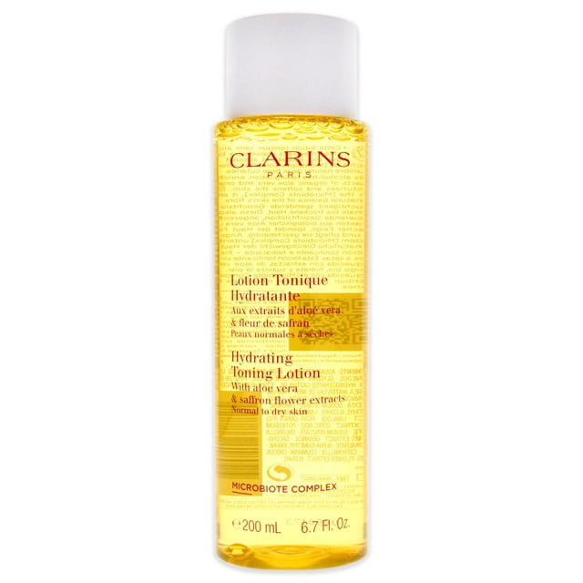 Clarins by Clarins, Toning Lotion - Normal/Dry Skin (New Packaging) in a 200ml/6.8oz bottle. The hydrating toning lotion is alcohol-free and enriched with plant extracts, including aloe vera and saffron flower, to balance and hydrate normal to dry skin. The clear bottle displays the golden liquid with red text detailing the product's features.