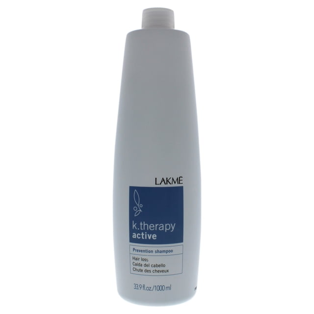 K-Therapy Active Shampoo by Lakme for Unisex - 33.9 oz Shampoo. A tall, cylindrical white bottle with a blue label featuring the product name and details. Designed to promote a healthy scalp, add volume to fine, thinning hair, and regulate sebaceous gland activity. Suitable for preventing hair aging and improving blood circulation.