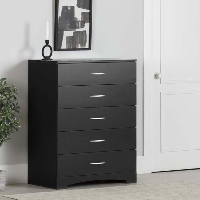 South Shore Step One 5-Drawer Chest for Adult in pure black with five drawers featuring silver metal handles and a curved kick plate base, shown front-facing in a minimalist room with a black and white abstract painting above and a white door nearby, ideal for compact bedroom storage and organization in kids' rooms.