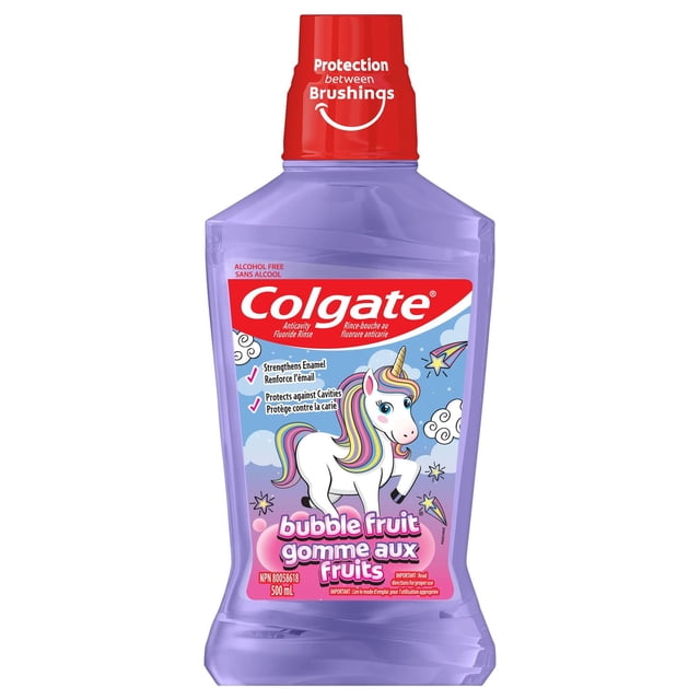 Colgate Kids Unicorn Mouthwash in a 500 mL translucent purple bottle with a red cap labeled 'Protection between Brushings.' The front label features a white unicorn with a rainbow mane, promoting bubble fruit flavor, anticavity fluoride rinse, enamel strengthening, and cavity protection. This alcohol-free mouthwash supports oral care between brushing for children.
