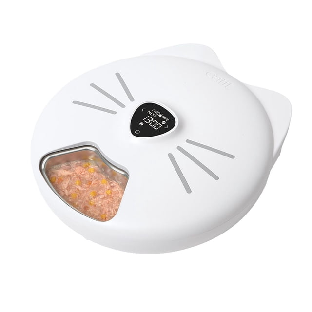 Catit PIXI Smart 6-Meal Cat Feeder with stainless steel tray, white cat-face shaped feeder with digital LCD screen and whisker accents, showing wet cat food with corn in the removable stainless steel tray, designed for app-controlled feeding of up to six meals daily with scheduled portion control.