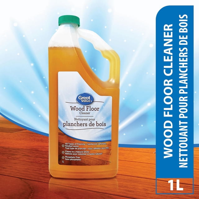 Great Value Wood Floor Cleaner 1L bottle with green cap containing amber liquid, suitable for hardwood, laminate, and finished wood floors, cleans to a natural shine, phosphate free, shown on a wood floor surface with a blue light background.