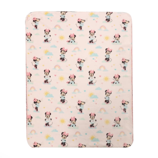 Disney Sherpa Baby Blanket featuring a repeating Minnie Mouse print with pink bows, pastel rainbows, suns, clouds, and hearts on a light pink background, made from soft breathable polyester with a sherpa reverse, measuring 30 by 40 inches, perfect for nursery bedding.