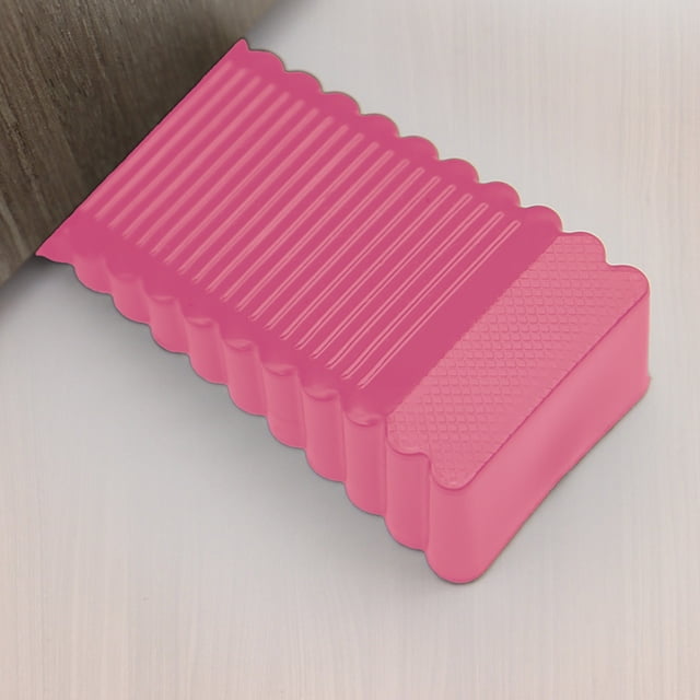Dvkptbk Door Stopper in pink, made of durable silica gel, designed to prevent doors from closing due to wind. The stopper features a ribbed texture for secure grip and a scalloped edge for added style. Compact size of 9.3 x 4 x 1.5 cm, suitable for various door gaps. Ideal for home, dorm, or office use.