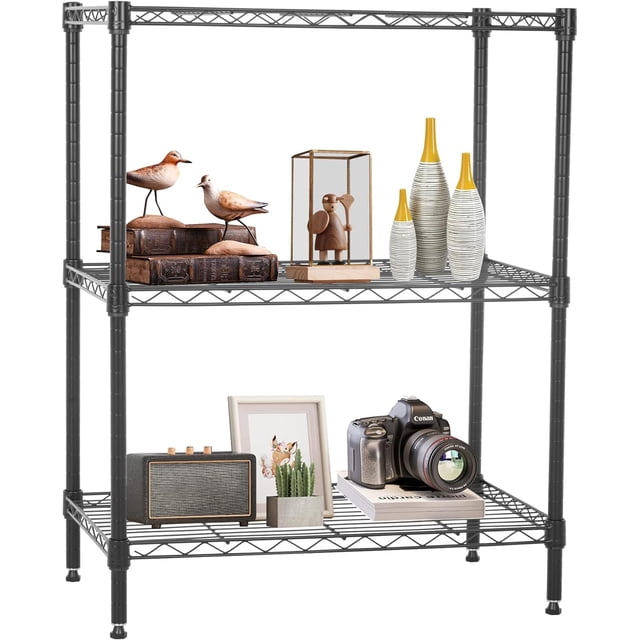 FDW Storage Shelves, Wire Shelving Unit Metal Shelves Heavy Duty Layer Rack Adjustable Utility in black. A three-tier metal shelving unit with adjustable wire shelves, shown holding decorative items such as books, figurines, vases, and a camera. The sturdy frame features adjustable leveling feet for stability on uneven surfaces. Ideal for garage storage, pantry organization, or home office use. Dimensions: 23 x 13 x 30 inches.