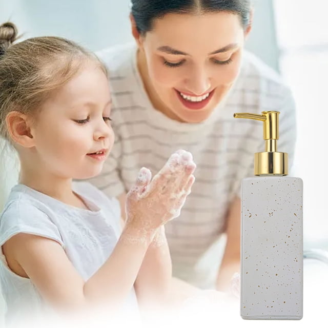 Foaming Soap Dispenser Foaming Hand Soap Refillable Dispenser for Bathroom or Kitchen. A white glass bottle with gold accents and a foam pump, designed for hand soap, body wash, or toiletries. Compact, refillable, and stylish for countertops.