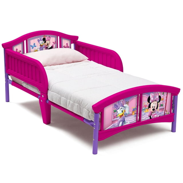 Disney Minnie Mouse Plastic Toddler Bed by Delta Children with pink and purple plastic frame and two attached guardrails, featuring colorful Minnie Mouse and Daisy Duck graphics on headboard and footboard, designed for toddlers transitioning from crib to bed using a standard crib mattress.
