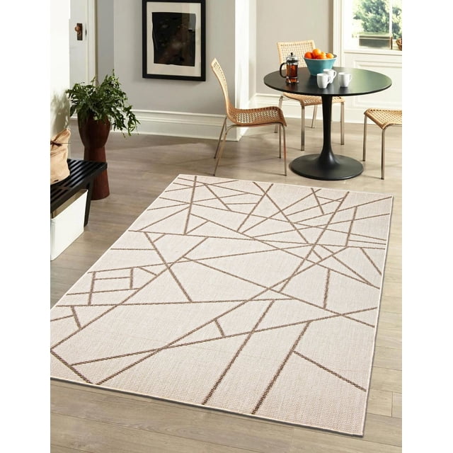 ECARPET Indoor Outdoor Area Rug for Patio, Deck, Living Room Sisal Abstract Collection in beige with brown geometric abstract lines, displayed on light wood flooring in a bright room with woven rattan chairs and a black round pedestal table holding a blue bowl of oranges, French press, and white mugs, ideal for both indoor and outdoor spaces.