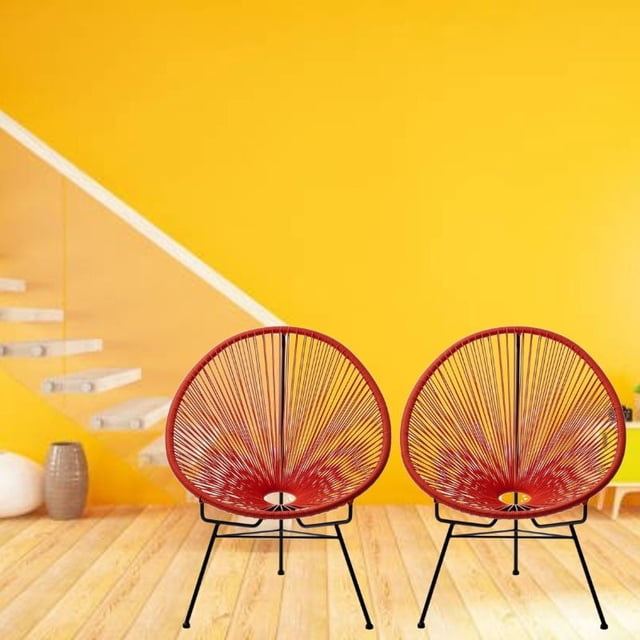 Costa Lounge Chair set of 2 in red Acapulco style wire design with black metal legs, on light wood floor against a yellow wall with floating stairs and decorative vases, suitable for indoor-outdoor patio use.
