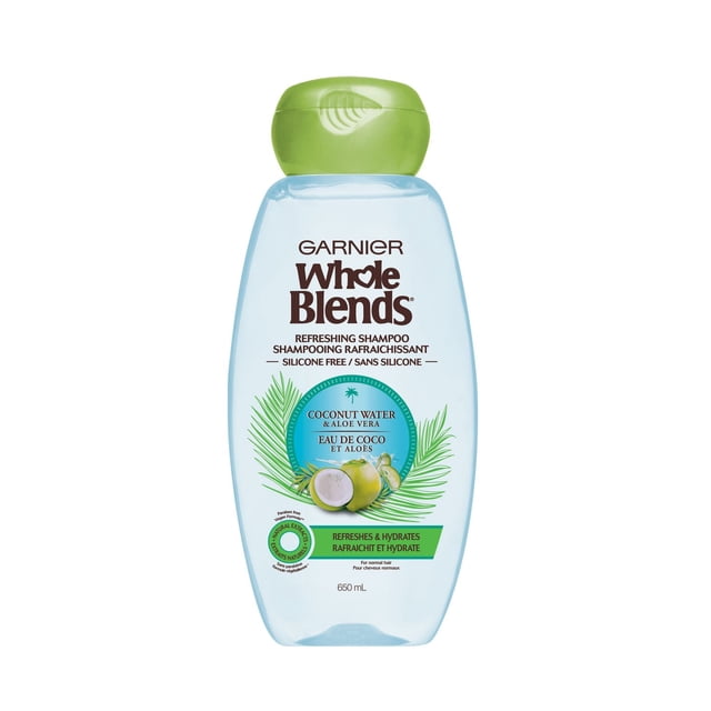 Whole Blends Coconut Water & Aloe Vera Shampoo by Garnier, a 650 mL translucent light blue bottle with a green flip-top cap, featuring a silicone-free, paraben-free formula with natural extracts that refreshes and hydrates normal hair with a fresh coconut and aloe vera scent.