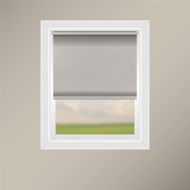Off Cut Shades Chainless Satin Back Roller Shade-Blush installed in a white window frame, featuring blush 100% polyester fabric with satin sheen and heathered interior. The shade has a plain hem with a sewn pocket and weighted insert on a sturdy white aluminum headrail. Its chainless design offers child and pet safety while providing privacy and a warm light glow, ideal for any room and decor style.