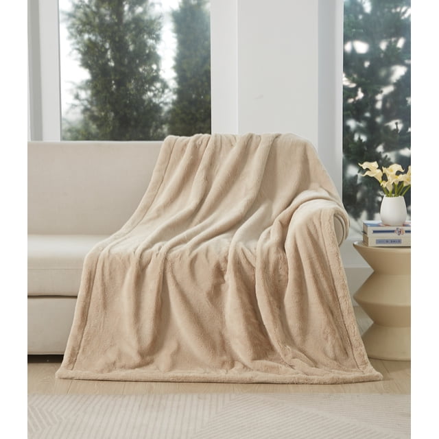 Better Homes & Gardens Faux Fur Throw, Beige, 50 x 72, oversized reversible faux fur throw draped over a beige sofa in a bright room with large windows and greenery outside, providing plush warmth and softness for couches or beds, often used as a decorative accent throw.