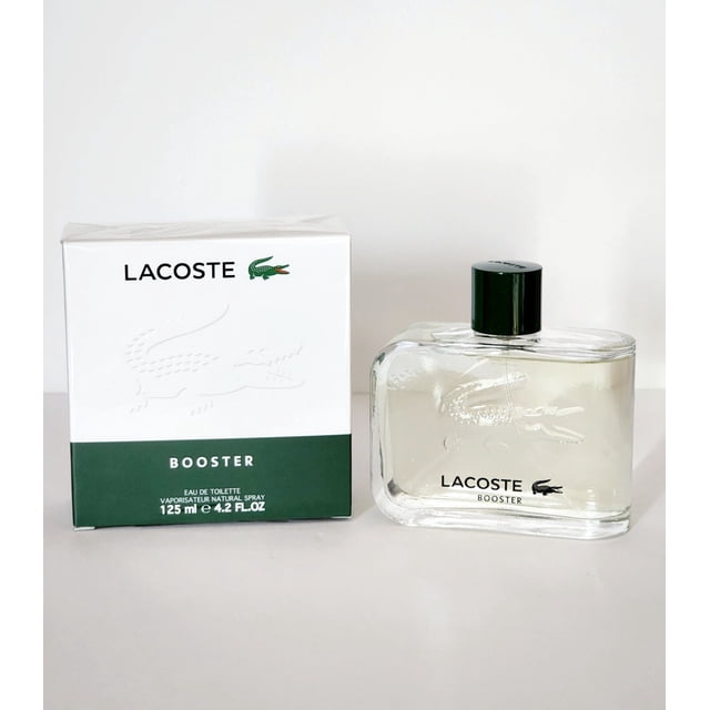 Booster by Lacoste Eau De Toilette Spray 4.2 oz, a men's fragrance launched in 1996, featuring a sharp, fruity scent with notes of menthol, lavender, eucalyptus, peppermint, and nutmeg. The image shows a clear glass bottle with the Lacoste logo and a matching box with green and white accents.
