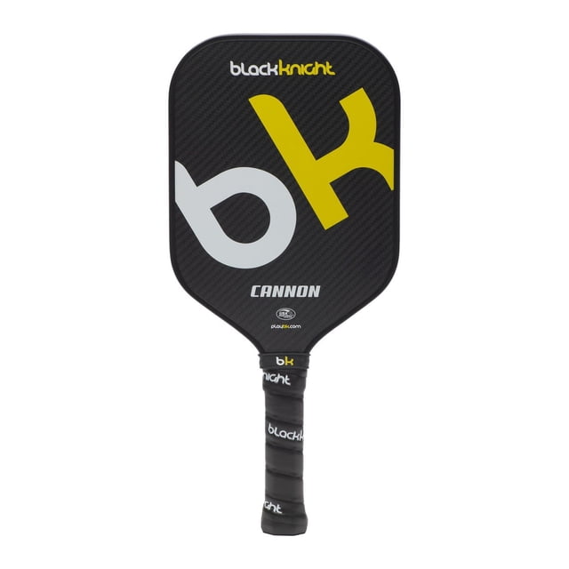 Black Knight Cannon pickleball paddle with elongated shape, black 3k woven carbon face featuring large yellow and gray 'bk' logo, polymer honeycomb core, and black grip wrapped with 'blackknight' text, midweight at 7.95oz, suitable for players seeking power and extra reach.