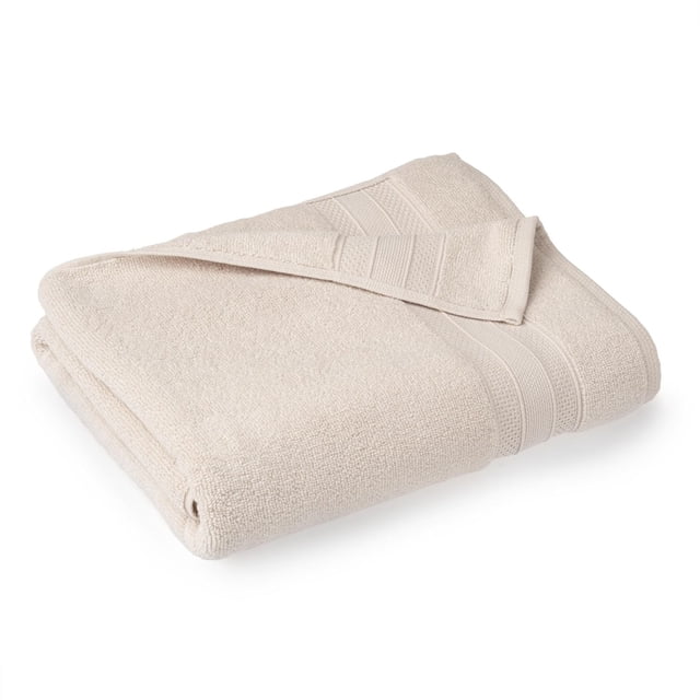 hometrends Solid 100% Cotton Bath Towel, 1 Piece, 550 GSM, cream-coloured highly absorbent and soft bathroom towel folded with visible textured cotton loops and ribbed decorative bands, suitable for spa-like bathroom comfort and often used as a lightweight wrap after bathing