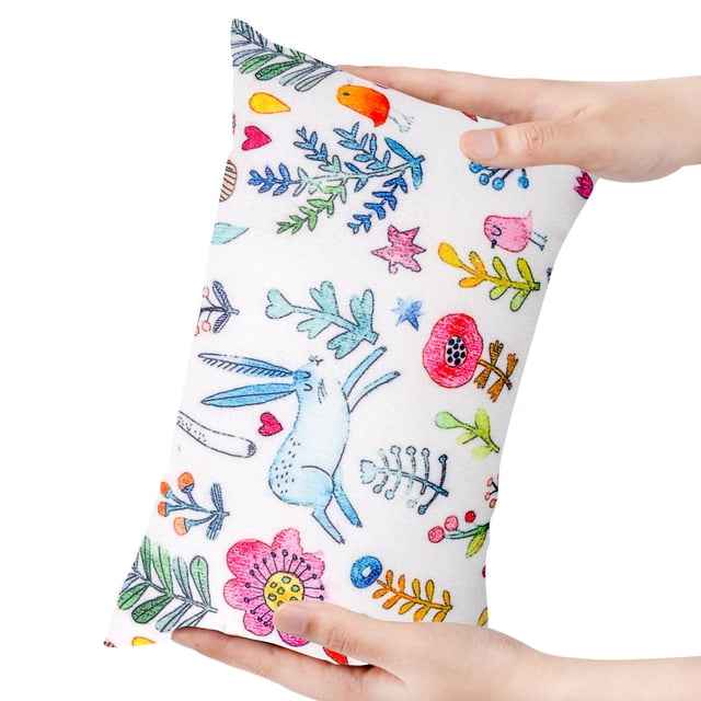 TopLLC Small Pillow For Kids, a compact 11 x 7 x 2.5-inch travel pillow with a colorful printed design featuring whimsical animals, flowers, and stars. The soft, breathable fabric is shown being held in hand, highlighting its lightweight and portable nature. Suitable for lumbar support, airplane, and car travel.
