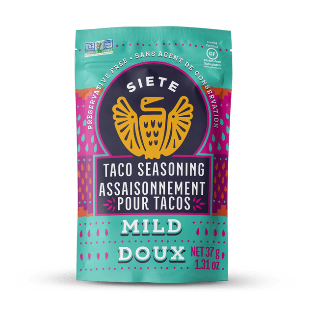 Siete Mild Taco Seasoning in a resealable turquoise and purple pouch with an orange bird logo, labeled preservative free, gluten free, non-GMO, and paleo, net weight 37 grams (1.31 oz), a versatile seasoning mix ideal for tacos, carnitas, chorizos, and vegetables.