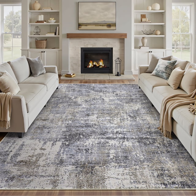 BERTHMEER 4'x6' Abstract Blue Gray Area Rug displayed in a living room with beige sofas, a lit fireplace, and built-in shelves. The rug features a modern abstract design in blue and gray tones, made of polyester and thermoplastic rubber with a low-pile height of 0.2 inches. It is machine washable, non-slip, and ideal for indoor use in living rooms, entryways, or offices, emphasizing washable rug functionality.