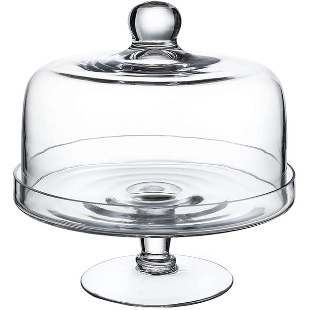WHOLE HOUSEWARES Glass Cake Stand with Dome featuring a clear glass dome lid with a knob handle and an elevated glass cake plate. The stand is designed for displaying cakes, cupcakes, pies, and pastries with a 360-degree view. Handmade from high-quality glass and wood, it serves as a versatile piece for use as a tray, platter, or centerpiece, ideal for kitchens, birthday parties, and weddings.