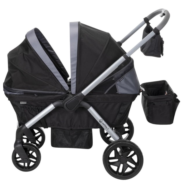 Safety 1st Summit Wagon Stroller in black and grey with two memory-foam seats featuring 3-point harnesses, dual vented canopies with 50+ UPF sun protection, a 3-position telescoping reversible handle, all-terrain wheels with rear suspension, linked braking system, and detachable storage bags.