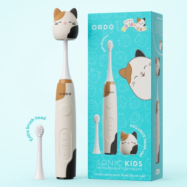 Ordo Sonic Kids Rechargeable Toothbrush – Squishmallows Cam - White, a white electric toothbrush with a cat-themed Squishmallows cap in cream, black, and brown patches, featuring a power button and three brushing modes. Includes an extra brush head with soft bristles and a turquoise box with Squishmallows branding, ideal for kids beauty gift sets.