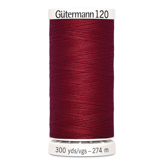 Gutermann 120 100% polyester all purpose thread spool in deep red, tightly wound on a white plastic spool labeled with 300 yards (274 meters), suitable for machine and hand sewing various fabrics including cotton, synthetics, and wool, also ideal for craft and mending projects.