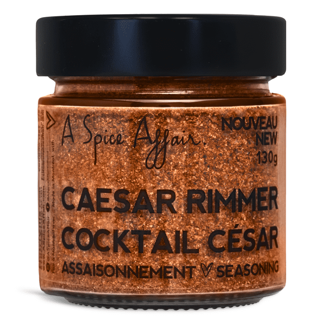 Caesar Rimmer & Seasoning A Spice Affair, 130g (4.6 oz) jar. A close-up view of the jar featuring a blend of Himalayan pink salt, celery seeds, red pepper, garlic, black pepper, and onion. The jar has a black lid and bold black text on the label, highlighting its use for classic Canadian Caesar cocktails and versatile seasoning for fish, seafood, and chicken.