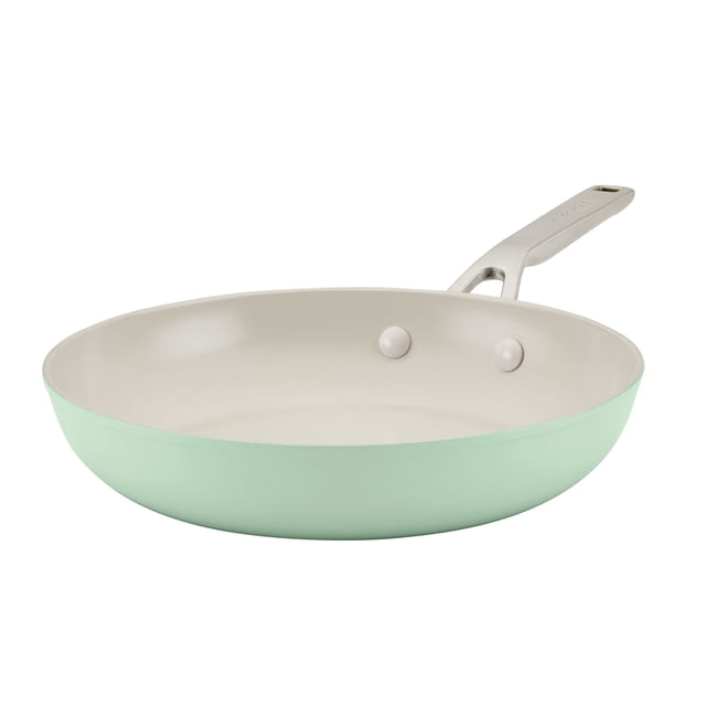 KitchenAid Hard Anodized Ceramic Fry Pan - 12.25"/31cm Pistachio. A pistachio-coloured frying pan with a ceramic nonstick interior and a sturdy metal handle. Made with a thick forged aluminum base for even heat distribution, it is 8x harder than aluminum and free from PFAS, PFOA, lead, and cadmium. Oven safe up to 500°F and backed by a limited lifetime warranty.