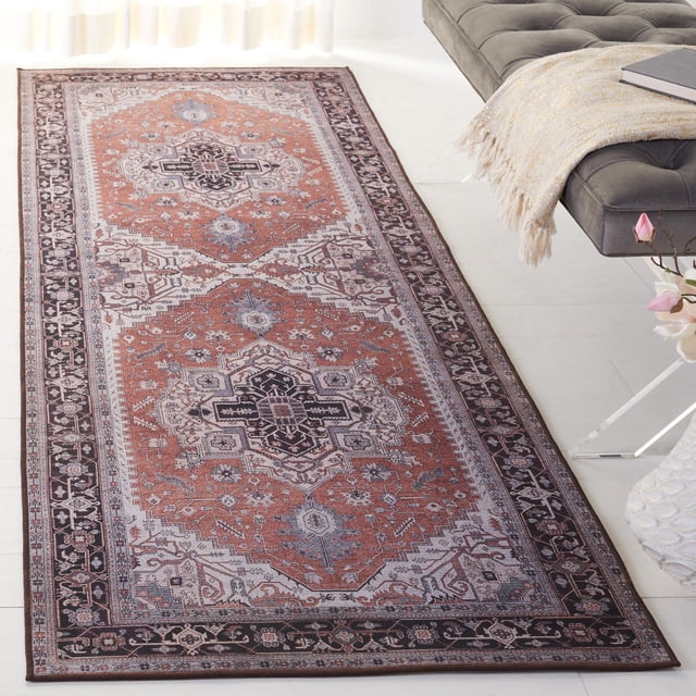 SAFAVIEH Tucson Drew Tapis Traditionnel Lavable à la Machine de Forme Rectangulaire avec Motifs Géométriques Traditionnels Rouille, beige et Noir, Tissé Mécaniquement avec des Fils Synthétiques Durables et un Endos Antidérapant pour une Stabilité Amortie, Présenté sur un Plancher Blanc à Côté d'Un Banc Capitonné Gris avec un Jeté beige et un Livre, Idéal pour un Lavage à la Machine Facile et une Utilisation durable dans les Espaces de Vie.