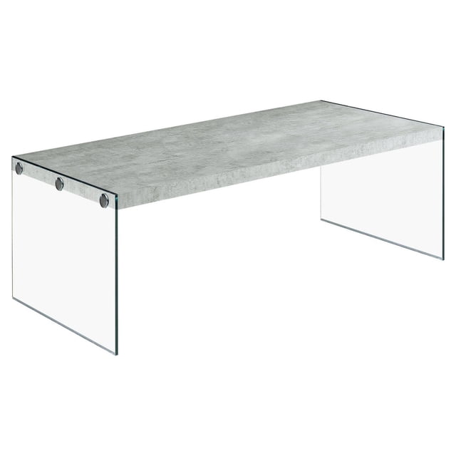 Monarch Specialties coffee table with a rectangular grey cement-look laminate top supported by clear tempered glass sides and metal fasteners, suitable as a modern accent or cocktail table in living rooms.