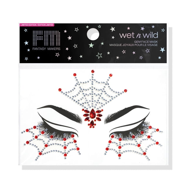 Fantasy Makers Gem Face Mark - Tangled Tease by wet n wild, a self-adhesive face mask featuring black stylized eyebrows and lashes with silver and red gem accents arranged in a spiderweb pattern around the eyes, suitable for festivals and parties, packaged with a black header decorated with pastel stars.