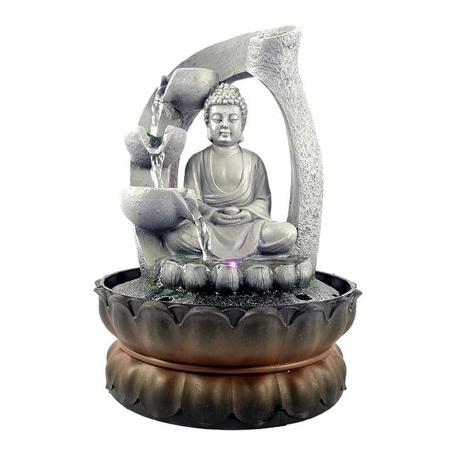 Indoor Buddha Fountain - Tabletop Water Fountain Table Waterfall Fountain featuring a sitting Buddha figure carved from polyresin with a stone-like finish. The fountain includes cascading water streams illuminated by LED lights, creating a tranquil and decorative ambiance. Compact and lightweight, measuring 21x21x28cm, it is suitable for desk or tabletop decoration. Equipped with a silent automatic pump for continuous water circulation.