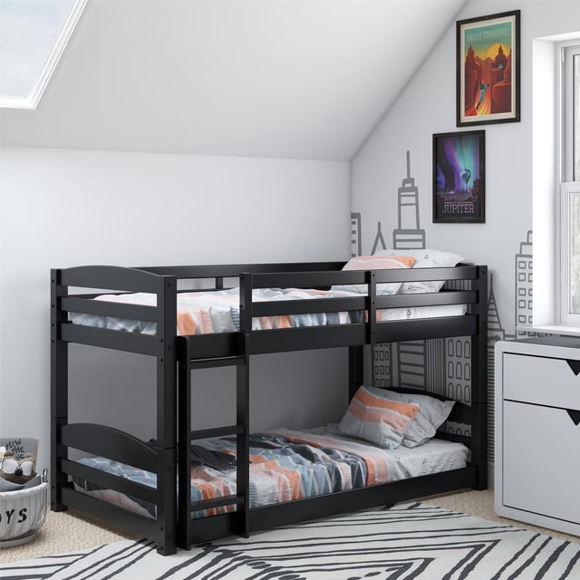 DHP Sierra black twin bunk beds for kids with safety rails and ladder in a modern bedroom setting.