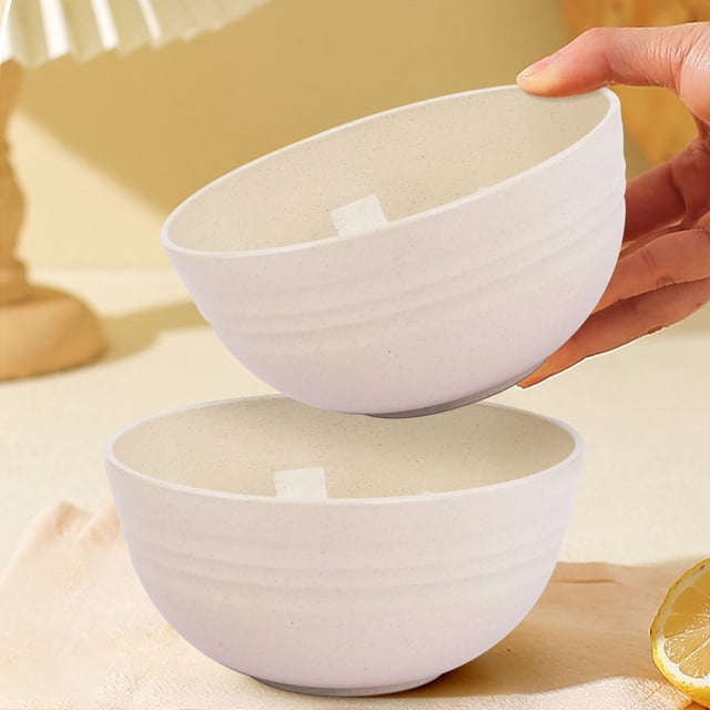 Plastic Bowls- Microwave- Dishwasher Safe Cereal Bowl Large 12x6cm X 1pcs. Two stackable, lightweight bowls made from eco-friendly wheat straw fiber, displayed in a neutral beige color with a textured, non-slip design. Ideal for kids, these bowls are versatile for cereal, soup, and pasta. Designed with rounded edges for easy handling, they are microwave and dishwasher safe, with a heat resistance of up to 248°F.
