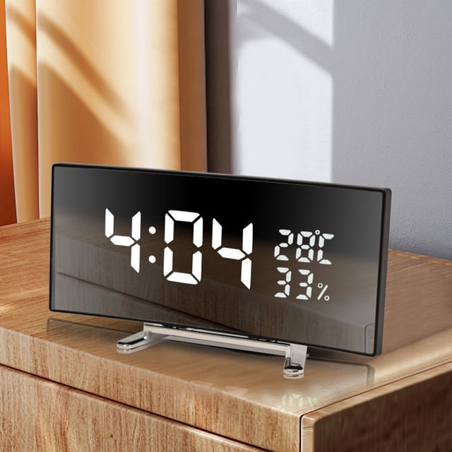 Drppepioner Multifunctional Intelligent Digital Mirror Clock with a large screen display, shown on a wooden desk. The clock features a sleek black mirror finish and displays the time, temperature, and humidity. It includes adjustable brightness settings, alarm functionality, and dual power options, making it suitable for home or office use.