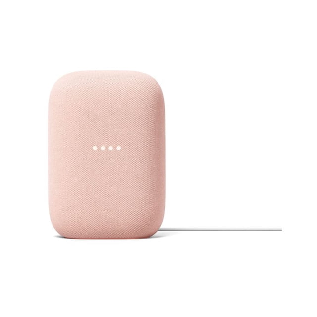 Google Nest Audio smart speaker in soft pink fabric with rounded rectangular shape, front-facing with four white LED dots, connected by a white power cable, delivering adaptive sound and smart home voice control in a wireless speaker design.