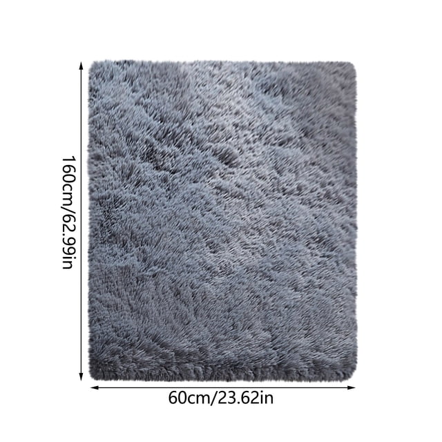 RKSTN Area Rug Soft Carpet Non-Slip Area Carpet measuring 60x160cm (23.62x62.99in) in a grey color. The rug features a plush, soft texture and a non-slip thermoplastic rubber backing for safety. Suitable for use in dining rooms, bedrooms, or as a versatile home decor piece. Ideal for indoor or outdoor use, it can also function as a tapestry, wall hanging, or picnic blanket. Low-profile design ensures doors do not get stuck. Easy to clean and maintain with vacuuming or machine washing.