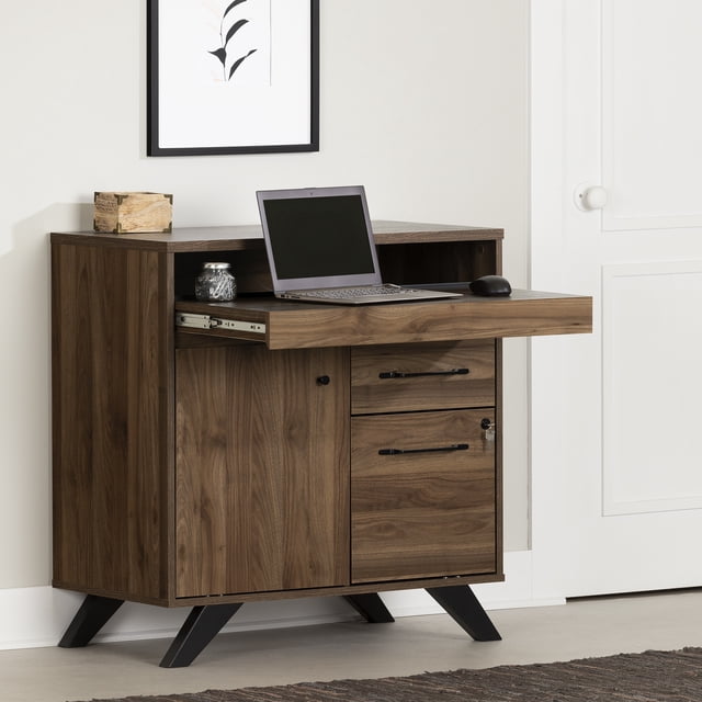 South Shore Flam Bureau de Secrétaire Multifonction Noyer Naturel avec Rallonge Coulissante Allongée Tenant un Ordinateur Portable et une Souris, avec Panneau de Particules Laminées Noyer Naturel à grain de Bois visible, Pattes Inclinées Noires, Armoire Gauche avec Tablette Réglable, Deux Tiroirs Droits Incluant un Tiroir de Classement Verrouillable, Posé contre un Mur Blanc avec un Imprimé Botanique Noir et Blanc Encadré au-Dessus. Ce Bureau Polyvalent Convient Aussi à l'Organisation des Fournitures de Bureau à Domicile dans les Espaces Compacts.